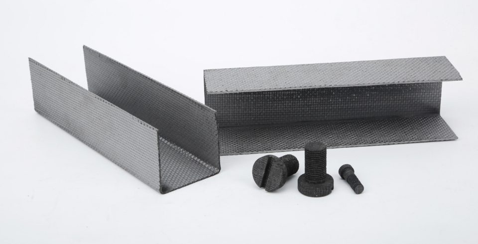 Carbon-carbon composite U plates and bolts are displayed.
