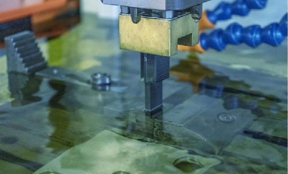 The graphite electrode is performing electrical discharge machining.