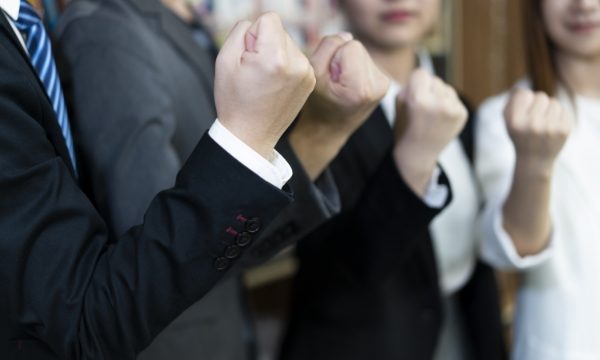 Team members are clenching their fists to cheer themselves up.