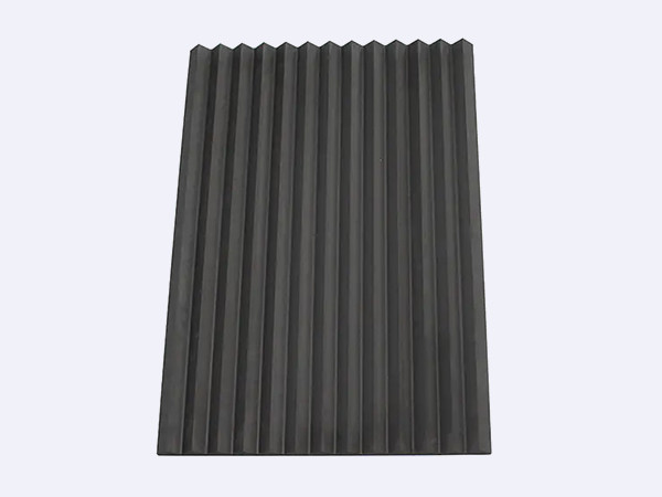A black graphite groove plate placed on a flat surface