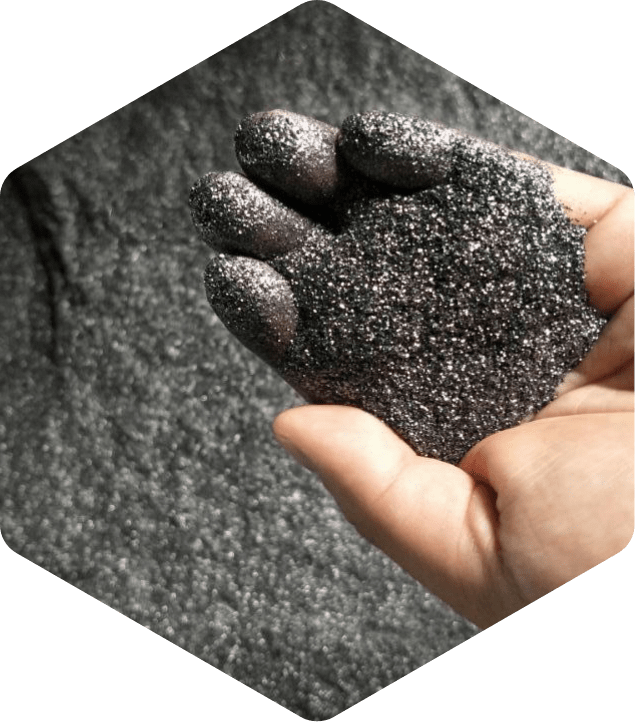 A man picked up a handful of graphite powder.