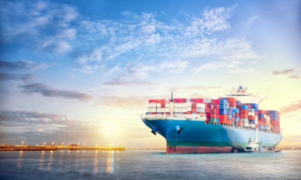 A large cargo ship is travelling on the sea.