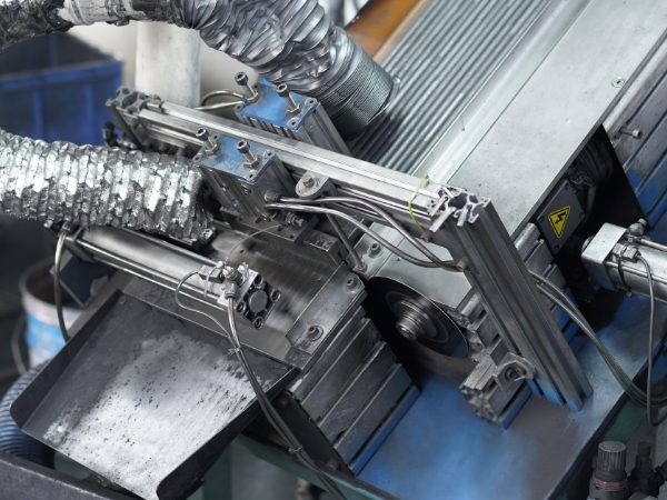 The machine is cutting the graphite rod into desired size.