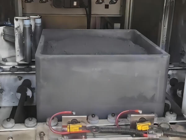 Automated machinery is capping the graphitized graphite sagger containing the material.