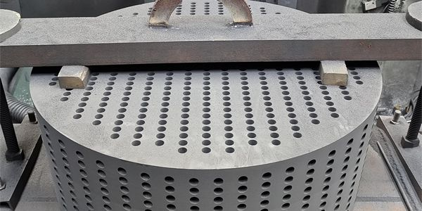 Impervious graphite heat exchange block is  pressed under an object.